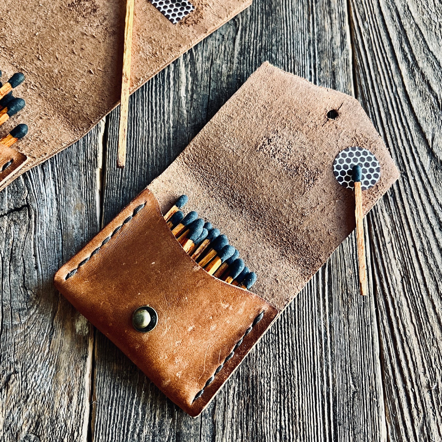 Shorty Leather Matchstick Case made by Sondera 1974 and featured on a wooden background