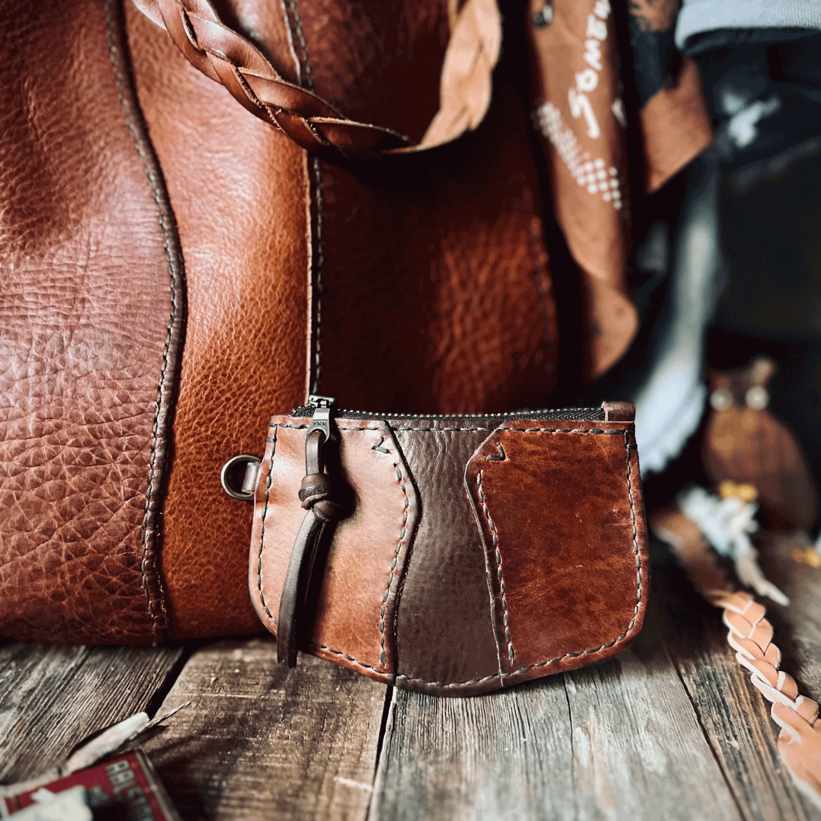 Brown leather bag on a wooden surface with blurred background