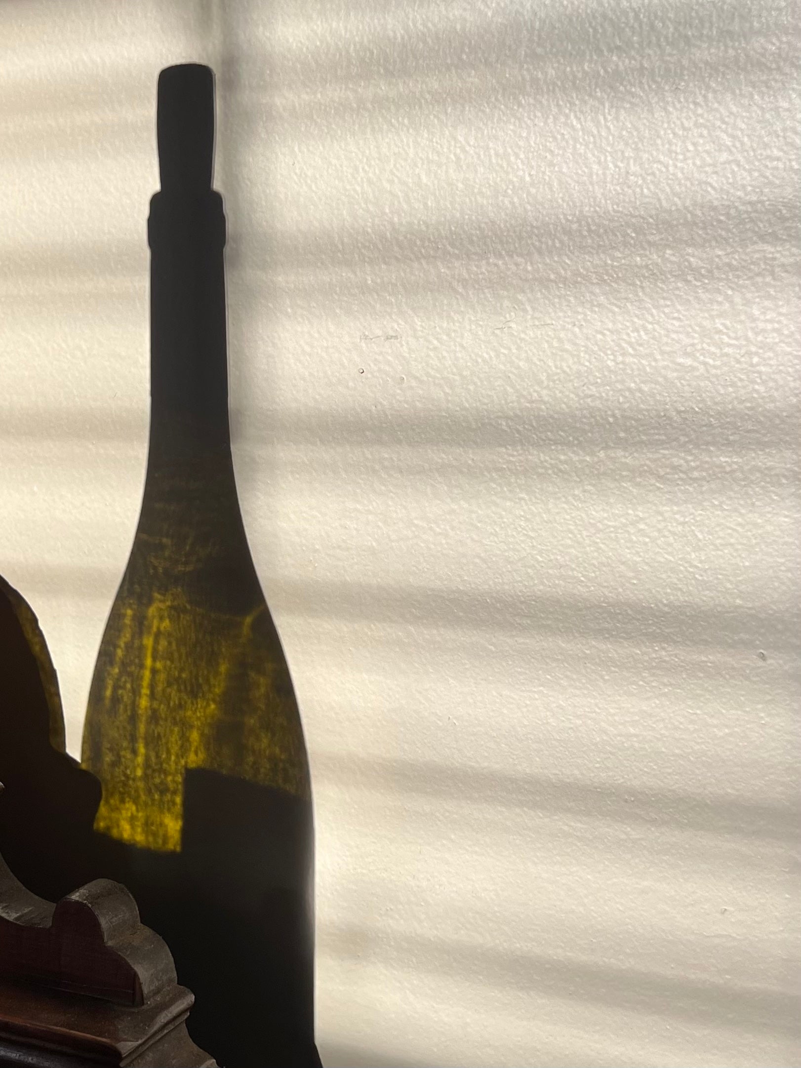 Wine bottle with a blurred label against a textured white background